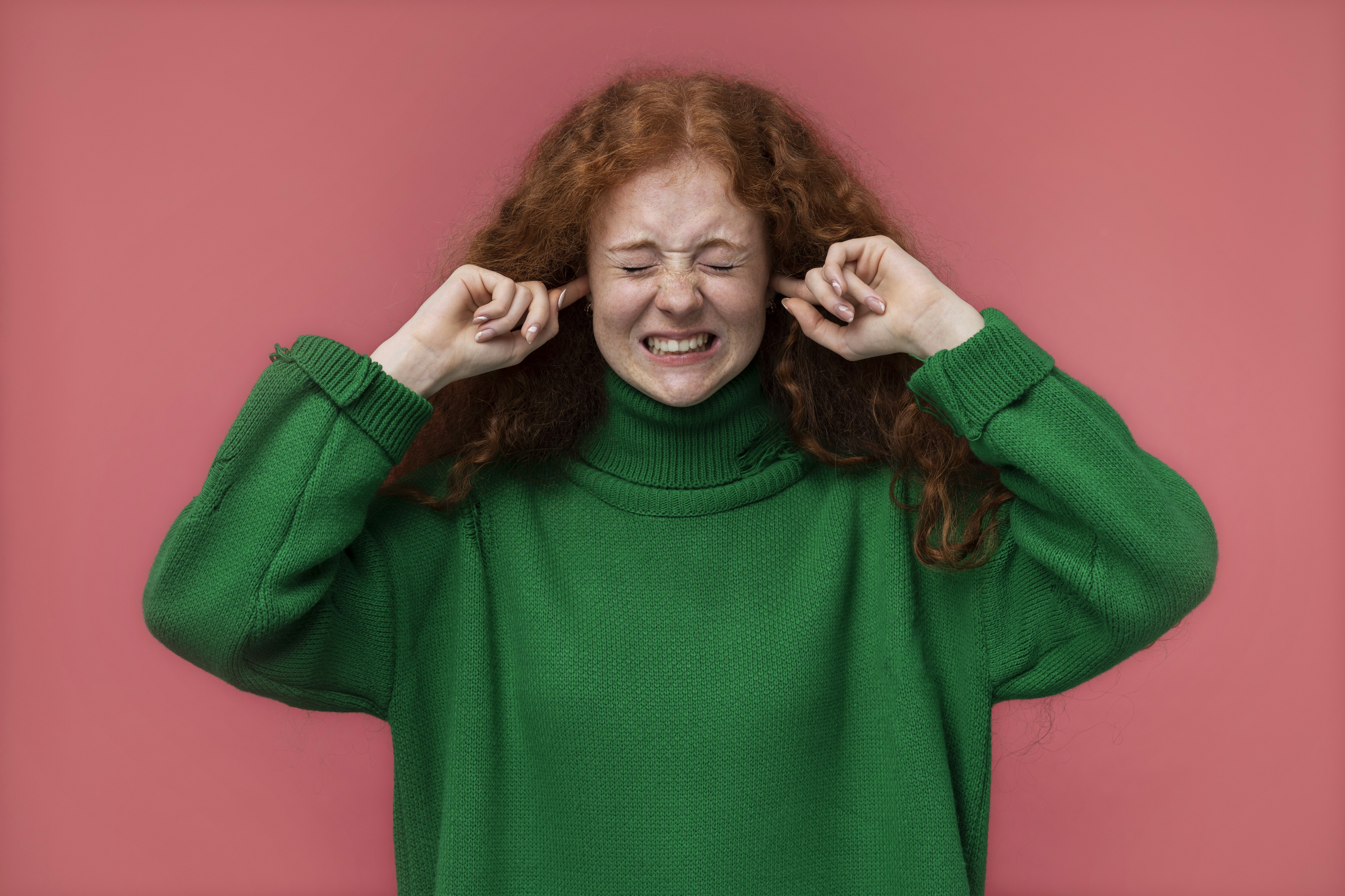 Portrait teenage girl covering her ears